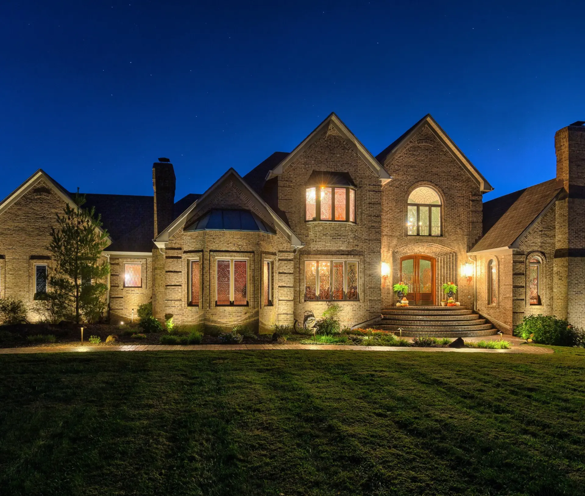 Warm low-voltage landscape lighting glowing at dusk