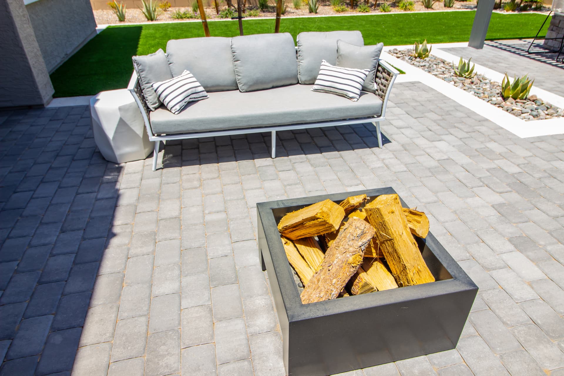 Modern paver patio with built-in fire pit and outdoor seating